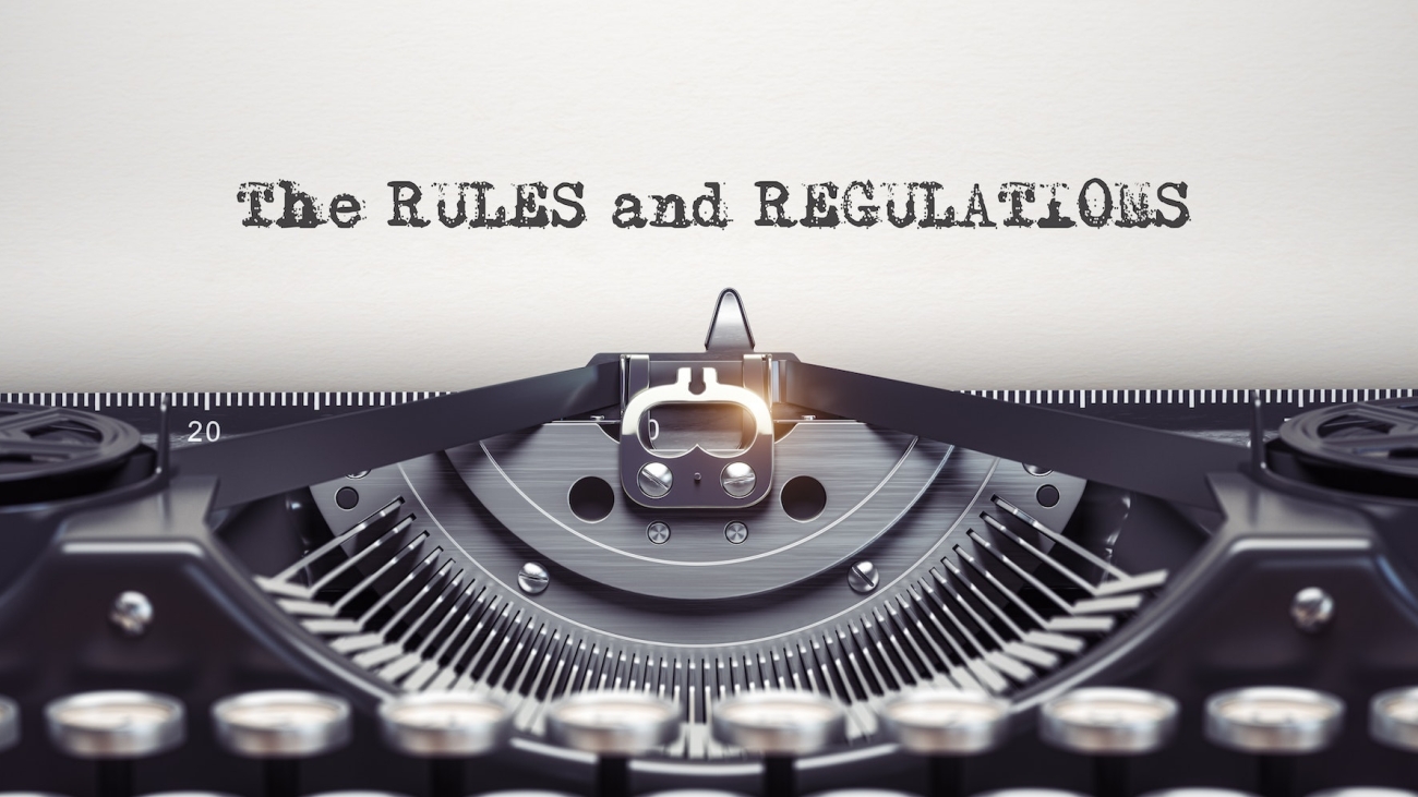 Rules and regulationswritten by typewriter. Typewriter and text on white sheet. Ilustrasi PSAK 24 - Pengertian dan Prinsip Dasar, membahas imbalan kerja dalam konteks akuntansi.